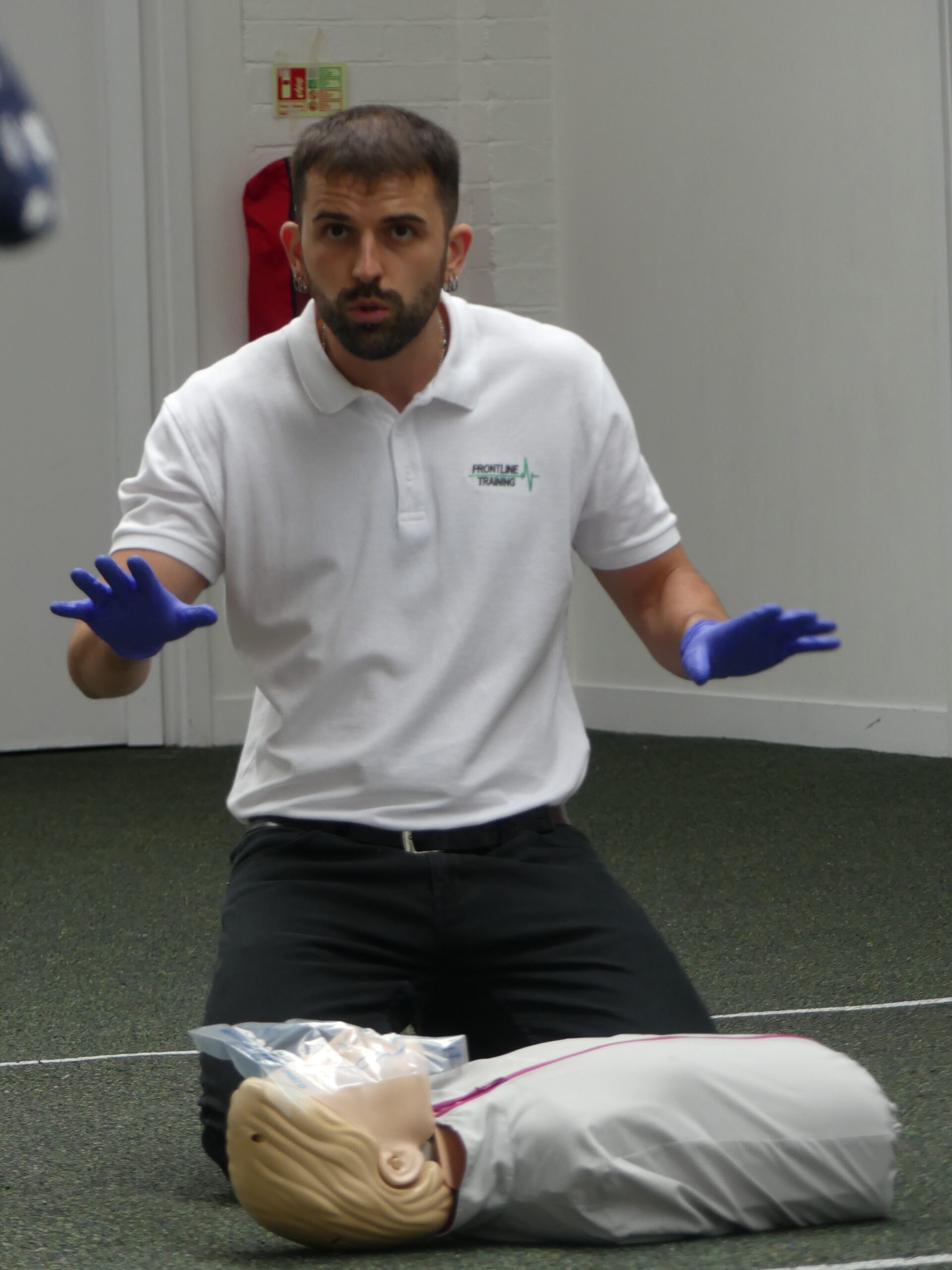 Frontline Training instructor demonstrating primary survey on a first aid course
