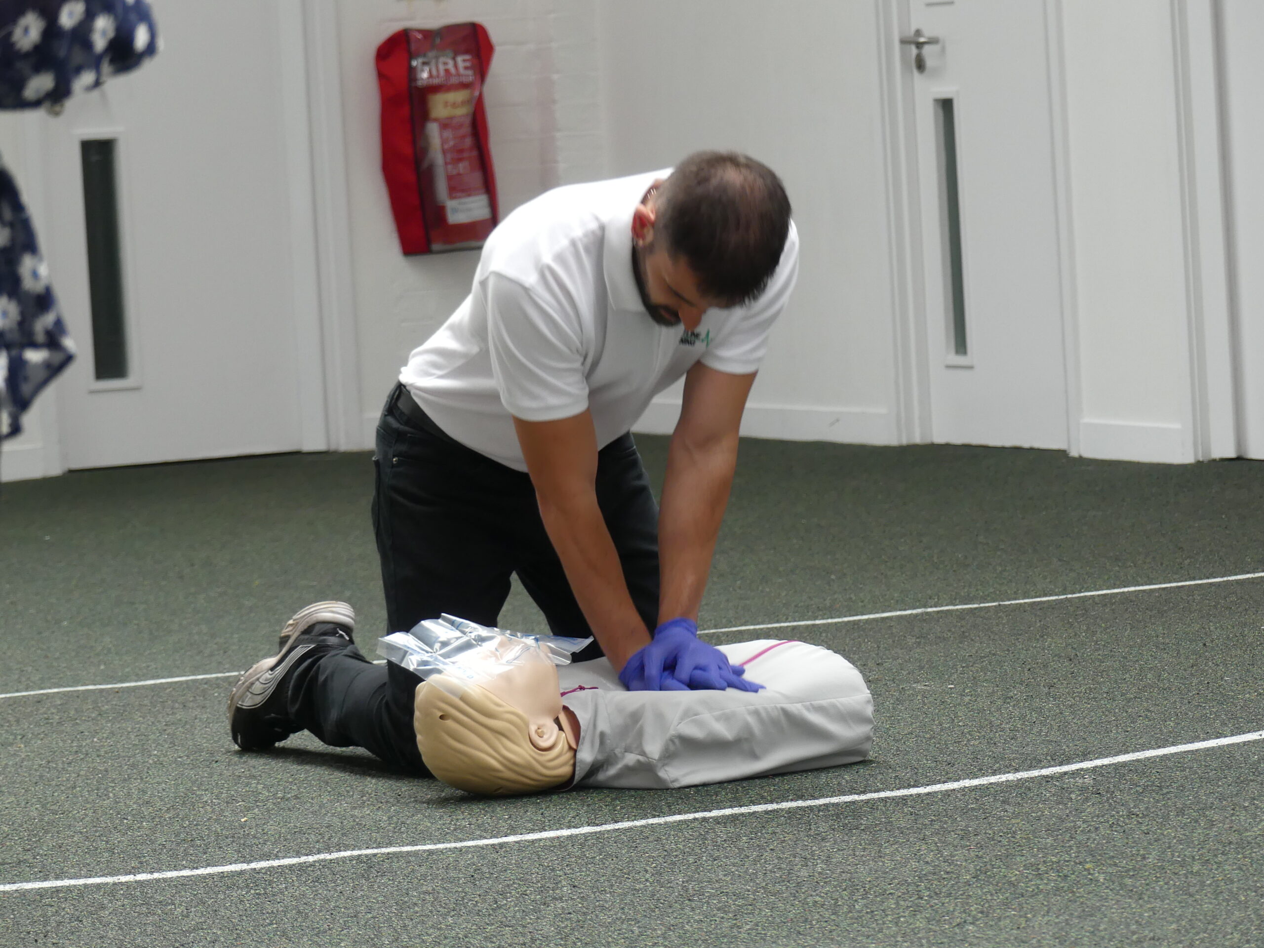 Frontline Training instructor demonstrating chest compressions on a first aid course