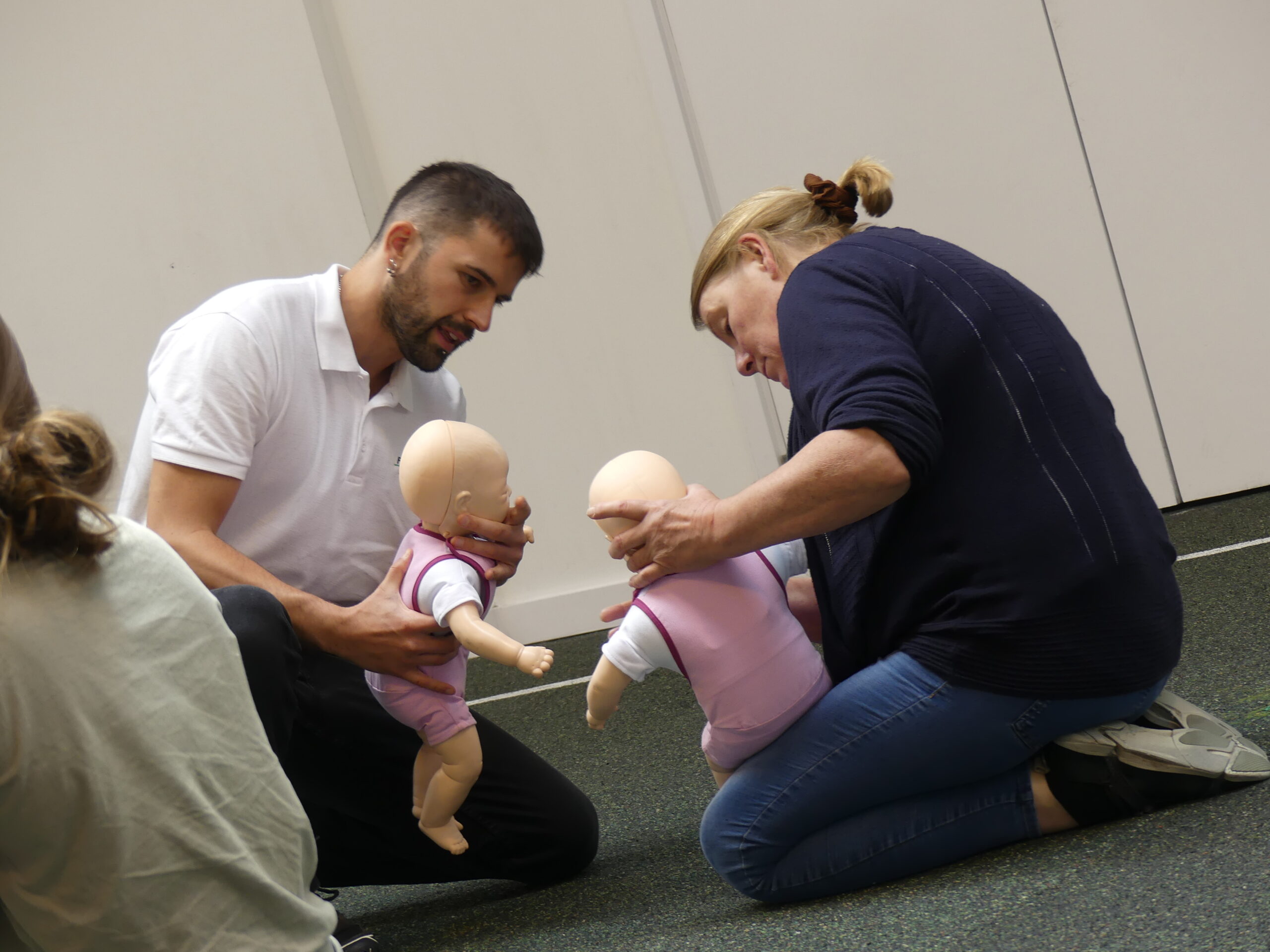 Frontline Training instructor coaching someone on airway management of an infant on a paediatric first aid course