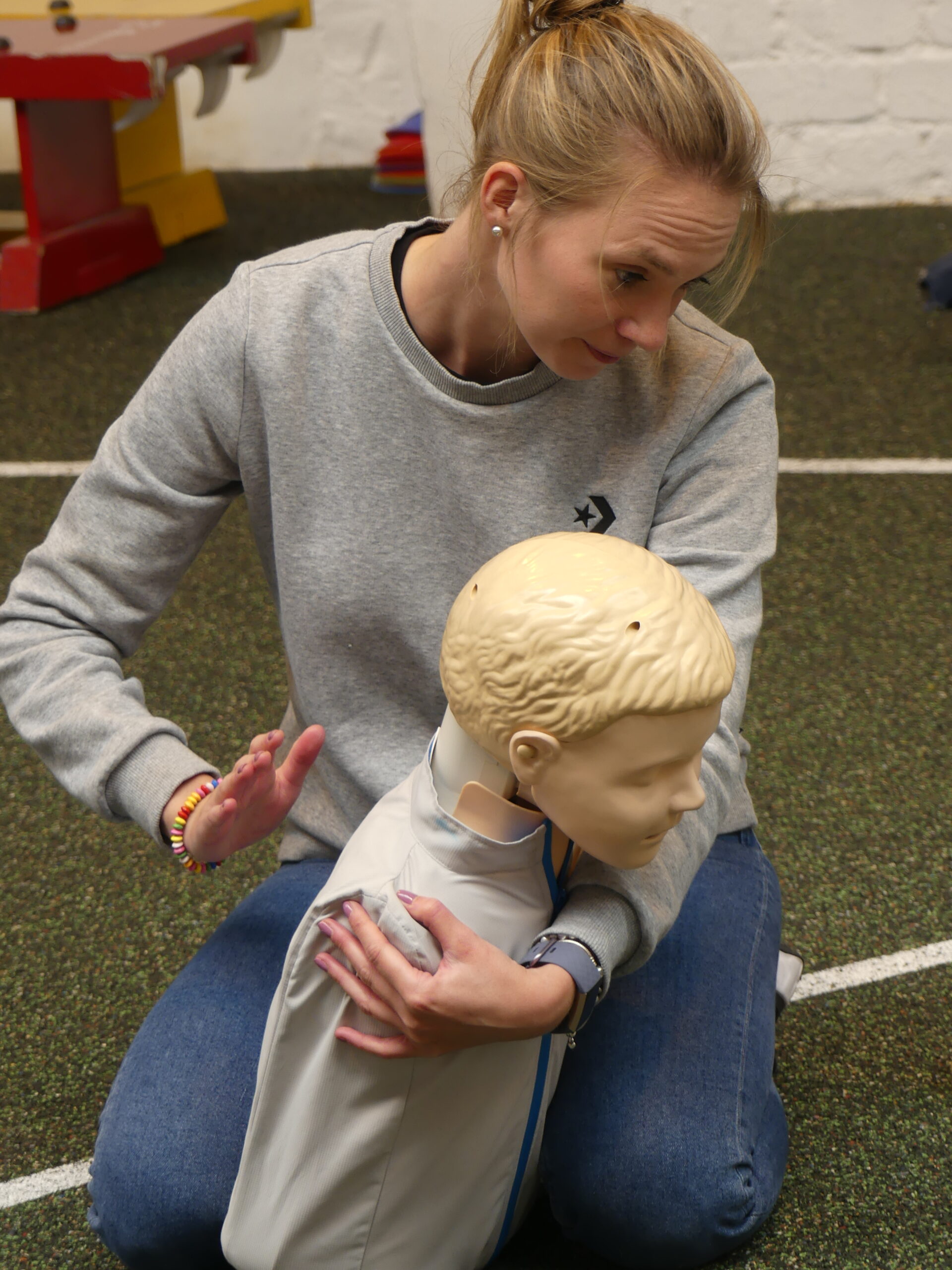 Learner practicing choking treatment on a paediatric first aid course