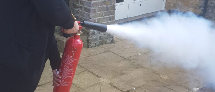 Using a Fire Extinguisher on a Fire Safety Course