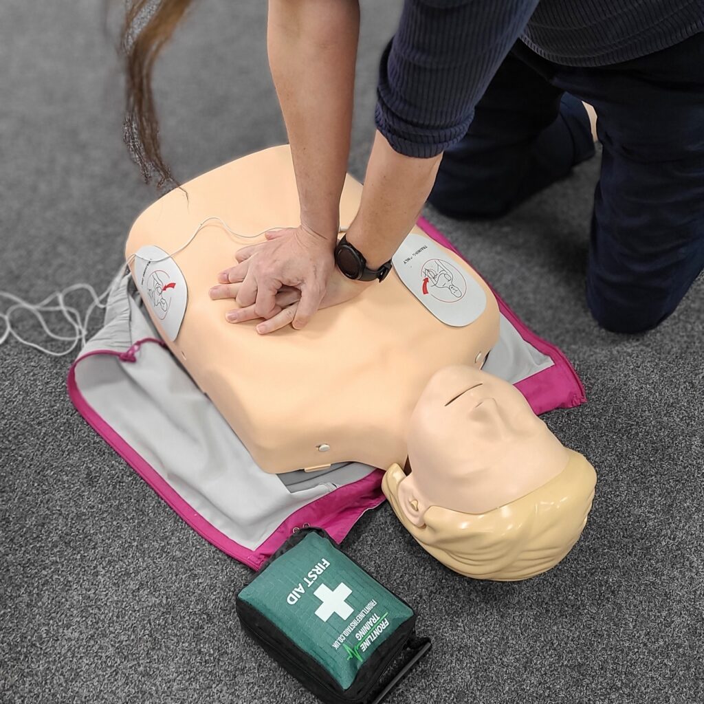 Giving CPR with defibrillator attached