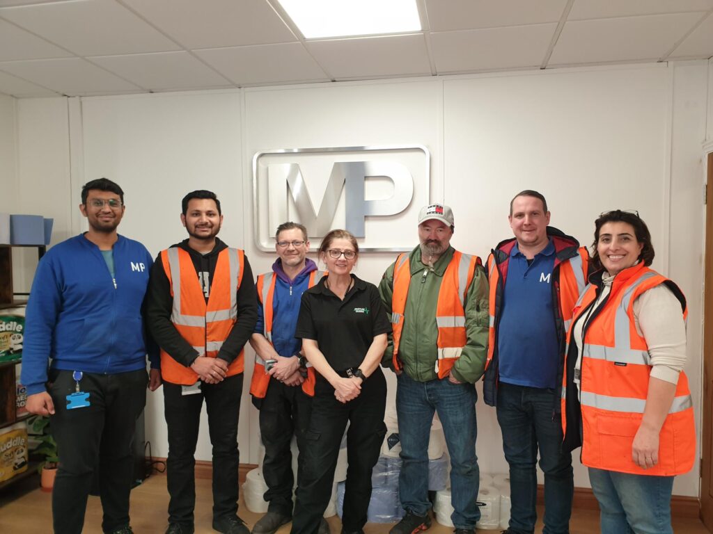 Trainer with a happy team after a health and safety course