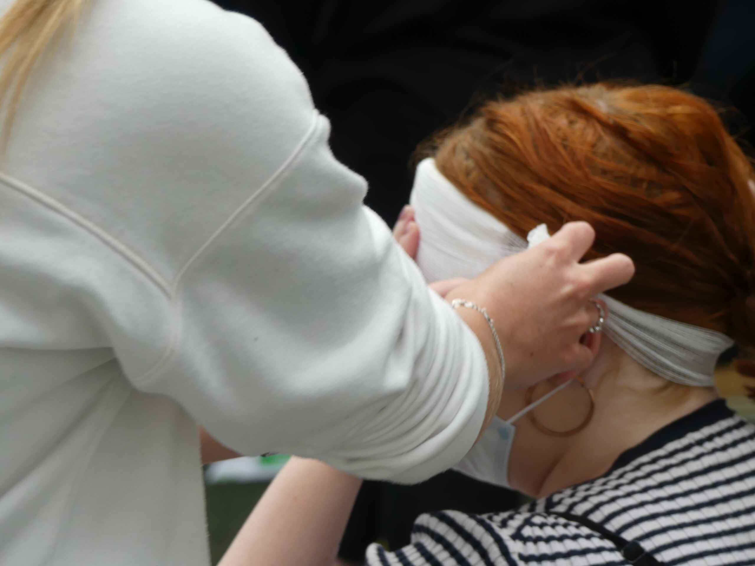 Learner practicing a head dressing ona  first aid course
