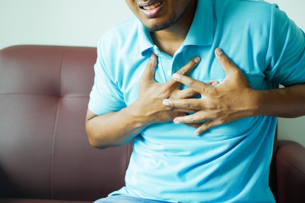 Man clutching chest potentially suffering heart attack