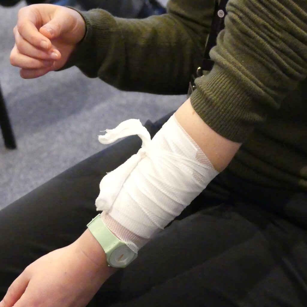 Wound dressing on bleeding arm